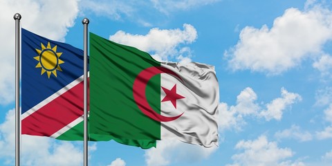 Namibia and Algeria flag waving in the wind against white cloudy blue sky together. Diplomacy...