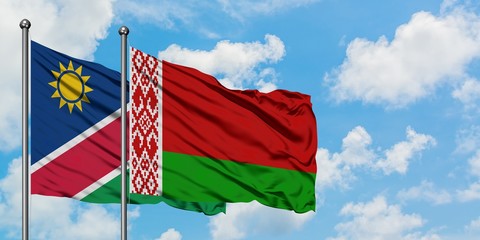 Namibia and Belarus flag waving in the wind against white cloudy blue sky together. Diplomacy concept, international relations.