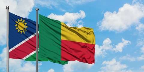 Namibia and Benin flag waving in the wind against white cloudy blue sky together. Diplomacy concept, international relations.