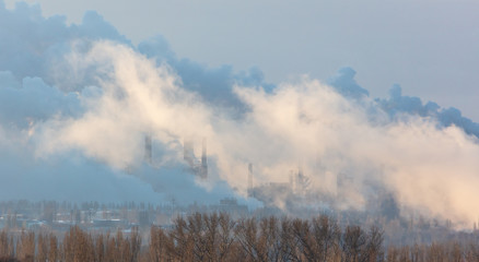 Obraz na płótnie Canvas Smoke from the factory at dawn