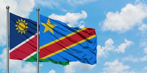 Namibia and Congo flag waving in the wind against white cloudy blue sky together. Diplomacy concept, international relations.