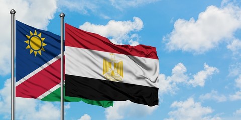 Namibia and Egypt flag waving in the wind against white cloudy blue sky together. Diplomacy concept, international relations.