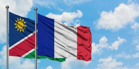 Namibia and France flag waving in the wind against white cloudy blue sky together. Diplomacy concept, international relations.