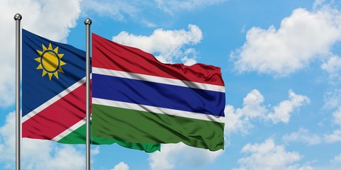 Namibia and Gambia flag waving in the wind against white cloudy blue sky together. Diplomacy concept, international relations.