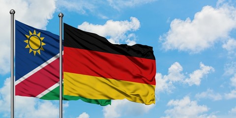Namibia and Germany flag waving in the wind against white cloudy blue sky together. Diplomacy concept, international relations.