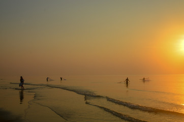  Tropical coastal sunrise landscape waterscape with net fishermen in the ocean water. Huay Yang,...
