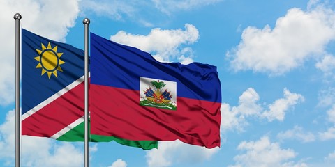 Namibia and Haiti flag waving in the wind against white cloudy blue sky together. Diplomacy concept, international relations.