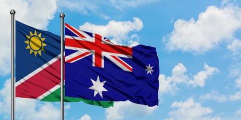 Namibia and Heard Island and Mcdonald Islands flag waving in the wind against white cloudy blue sky...