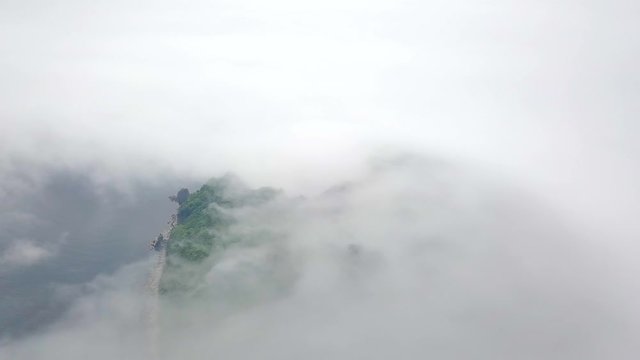 Shooting from above. Green desert island in the fog. The reserved island of Petrov in the Lazovsky reserve in the fog. The island with the world's only yew grove.