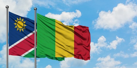 Namibia and Mali flag waving in the wind against white cloudy blue sky together. Diplomacy concept, international relations.