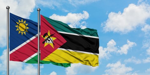 Namibia and Mozambique flag waving in the wind against white cloudy blue sky together. Diplomacy concept, international relations.