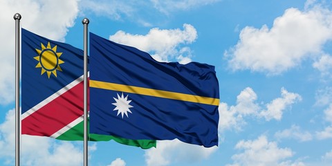 Namibia and Nauru flag waving in the wind against white cloudy blue sky together. Diplomacy concept, international relations.