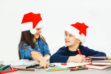 Happy little children in Santa hats on white background. Christmas celebration