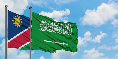 Namibia and Saudi Arabia flag waving in the wind against white cloudy blue sky together. Diplomacy concept, international relations.