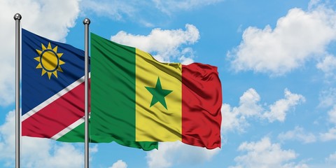 Namibia and Senegal flag waving in the wind against white cloudy blue sky together. Diplomacy concept, international relations.