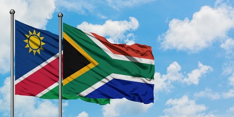 Namibia and South Africa flag waving in the wind against white cloudy blue sky together. Diplomacy concept, international relations.