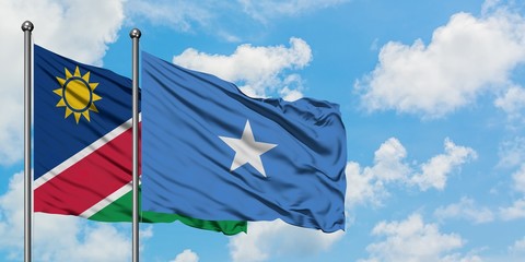 Namibia and Somalia flag waving in the wind against white cloudy blue sky together. Diplomacy concept, international relations.