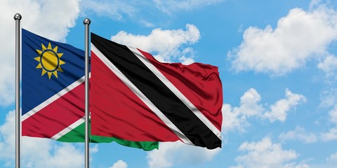 Namibia and Trinidad And Tobago flag waving in the wind against white cloudy blue sky together. Diplomacy concept, international relations.