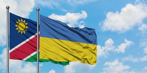 Namibia and Ukraine flag waving in the wind against white cloudy blue sky together. Diplomacy concept, international relations.