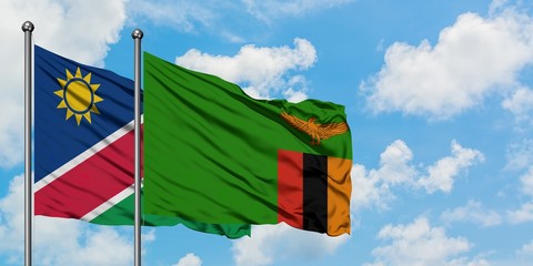 Namibia and Zambia flag waving in the wind against white cloudy blue sky together. Diplomacy concept, international relations.