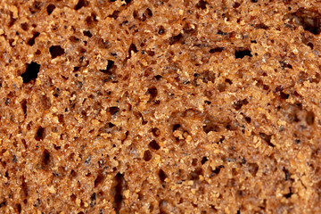 Black rye bread as an abstract background