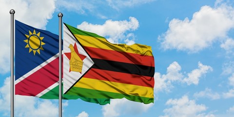 Namibia and Zimbabwe flag waving in the wind against white cloudy blue sky together. Diplomacy concept, international relations.