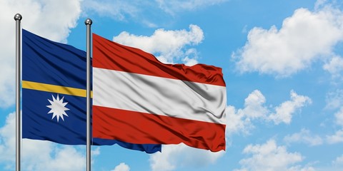 Nauru and Austria flag waving in the wind against white cloudy blue sky together. Diplomacy concept, international relations.
