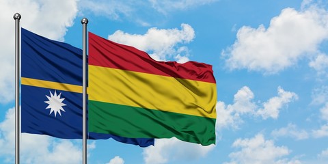 Nauru and Bolivia flag waving in the wind against white cloudy blue sky together. Diplomacy concept, international relations.