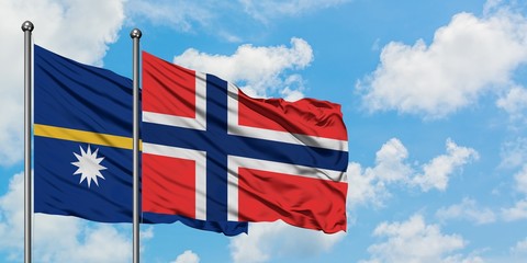 Nauru and Bouvet Islands flag waving in the wind against white cloudy blue sky together. Diplomacy concept, international relations.