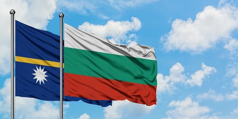 Nauru and Bulgaria flag waving in the wind against white cloudy blue sky together. Diplomacy concept, international relations.