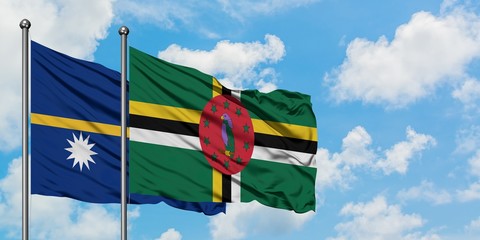 Nauru and Dominica flag waving in the wind against white cloudy blue sky together. Diplomacy concept, international relations.