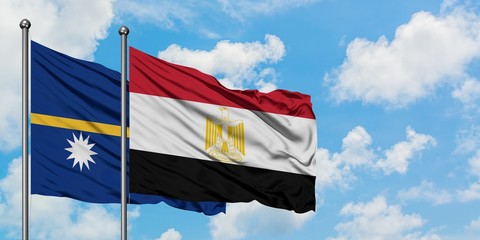 Nauru and Egypt flag waving in the wind against white cloudy blue sky together. Diplomacy concept, international relations.