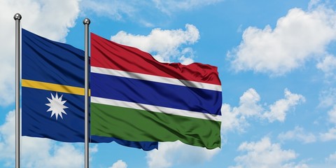 Nauru and Gambia flag waving in the wind against white cloudy blue sky together. Diplomacy concept, international relations.