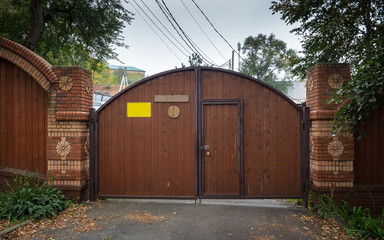 Fototapeta premium Urban landscape. Large gate and brick wall