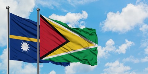 Nauru and Guyana flag waving in the wind against white cloudy blue sky together. Diplomacy concept,...