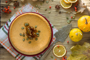 Thanksgiving pumpkin cake  top view, copy space. Fall traditional homemade pumpkin pie or cheesecake  for autumn holiday.