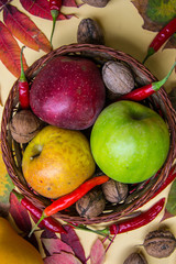 Colorful autumn still life composition, flat lay top view, colorful apples in a basket, pumpkin, leaves, pods and pinecones, nature concept