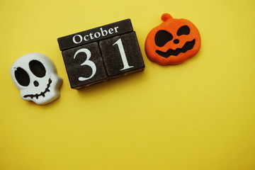 Halloween 31 october with skull and pumpkin decorate with space copy on yellow background