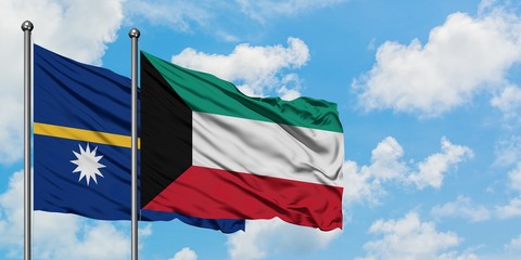 Nauru and Kuwait flag waving in the wind against white cloudy blue sky together. Diplomacy concept, international relations.