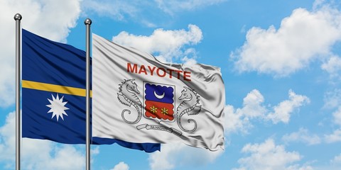 Nauru and Mayotte flag waving in the wind against white cloudy blue sky together. Diplomacy concept, international relations.