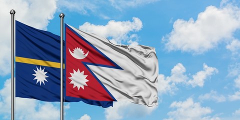 Nauru and Nepal flag waving in the wind against white cloudy blue sky together. Diplomacy concept, international relations.
