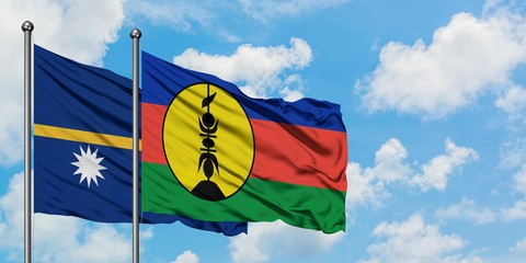 Nauru and New Caledonia flag waving in the wind against white cloudy blue sky together. Diplomacy concept, international relations.