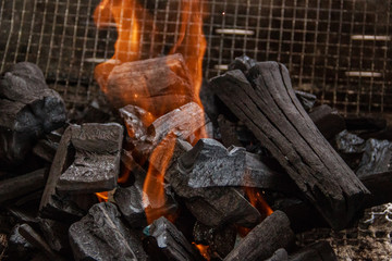 Charcoal burns in the grill