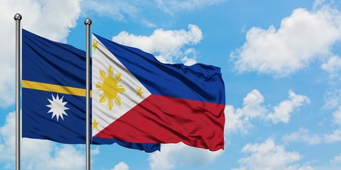 Nauru and Philippines flag waving in the wind against white cloudy blue sky together. Diplomacy concept, international relations.