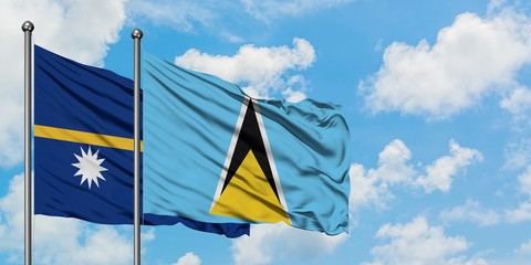 Nauru and Saint Lucia flag waving in the wind against white cloudy blue sky together. Diplomacy concept, international relations.
