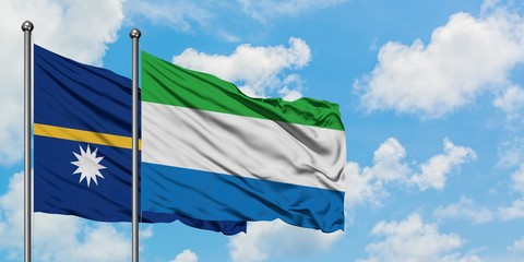 Nauru and Sierra Leone flag waving in the wind against white cloudy blue sky together. Diplomacy concept, international relations.