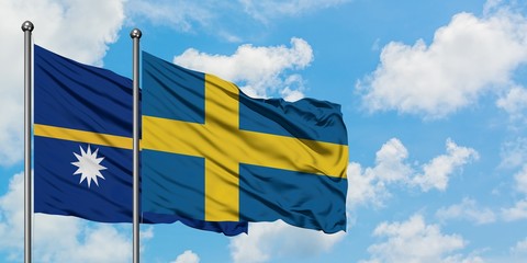 Nauru and Sweden flag waving in the wind against white cloudy blue sky together. Diplomacy concept, international relations.