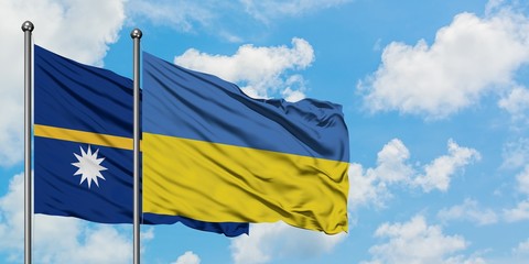 Nauru and Ukraine flag waving in the wind against white cloudy blue sky together. Diplomacy concept, international relations.