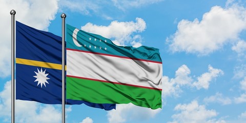 Nauru and Uzbekistan flag waving in the wind against white cloudy blue sky together. Diplomacy concept, international relations.
