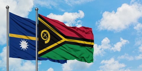 Nauru and Vanuatu flag waving in the wind against white cloudy blue sky together. Diplomacy concept, international relations.